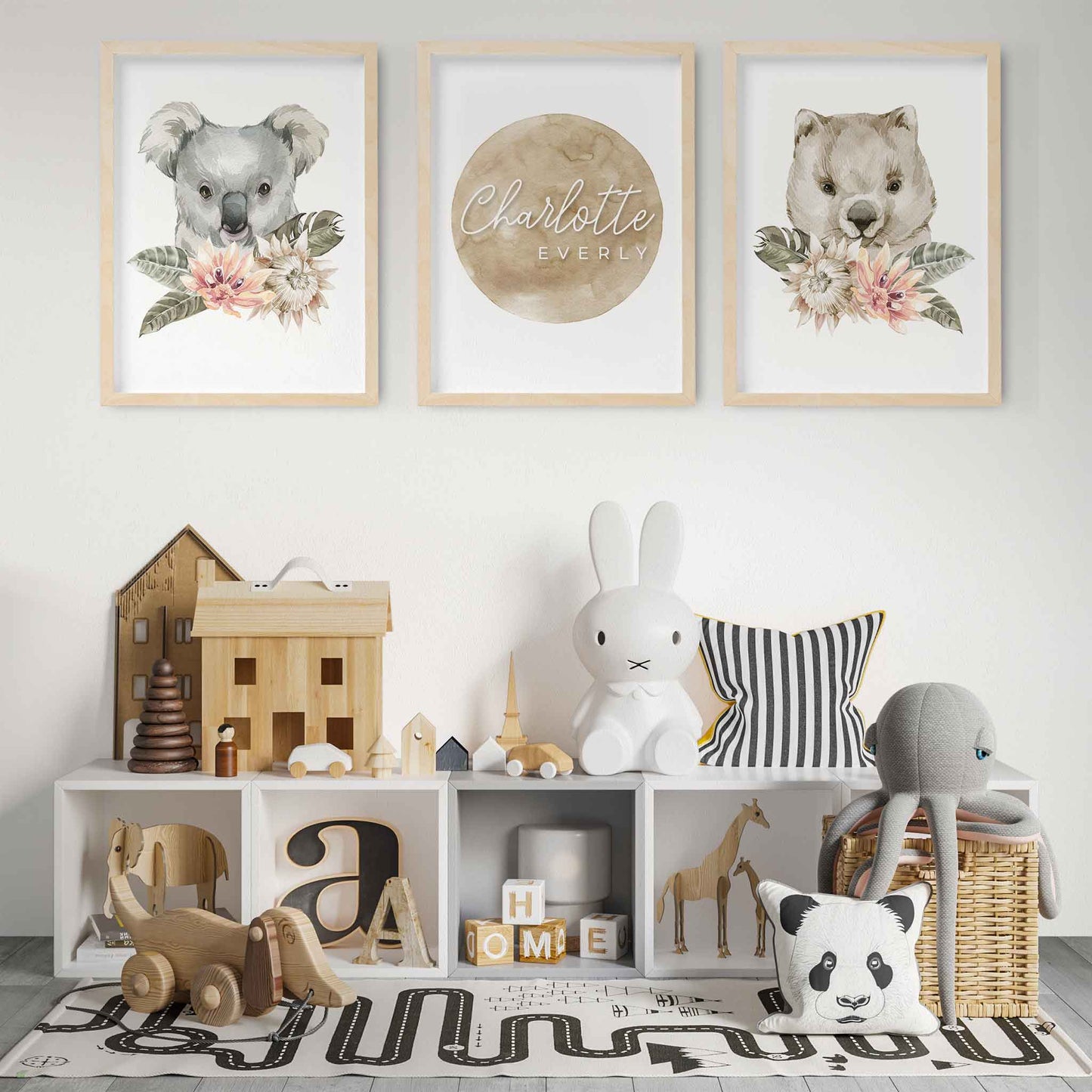 A set of 3 wall oak framed images of Australian wombat and koala featuring a personalised kids name plaque in a child's playroom