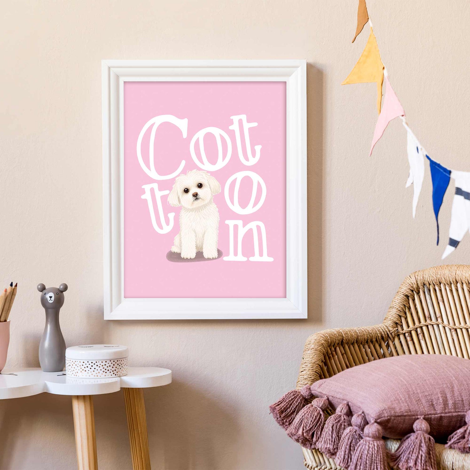 Framed kids pet portrait with a dog illustration and 'Cotton' text on a pink background, displayed in a room.