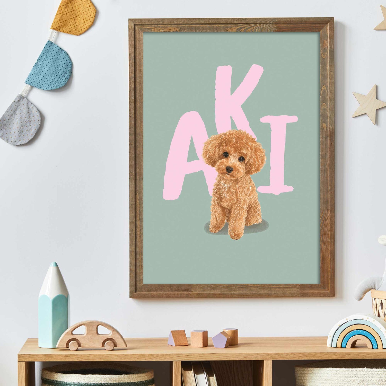 Framed kids pet portrait  with a dog illustration and 'AKI' text in a child's room.
