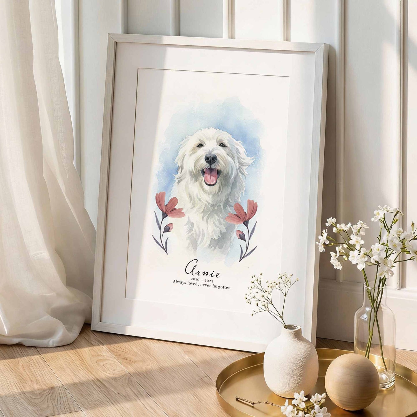 Framed portrait of a white dog with floral elements on a light wooden floor.