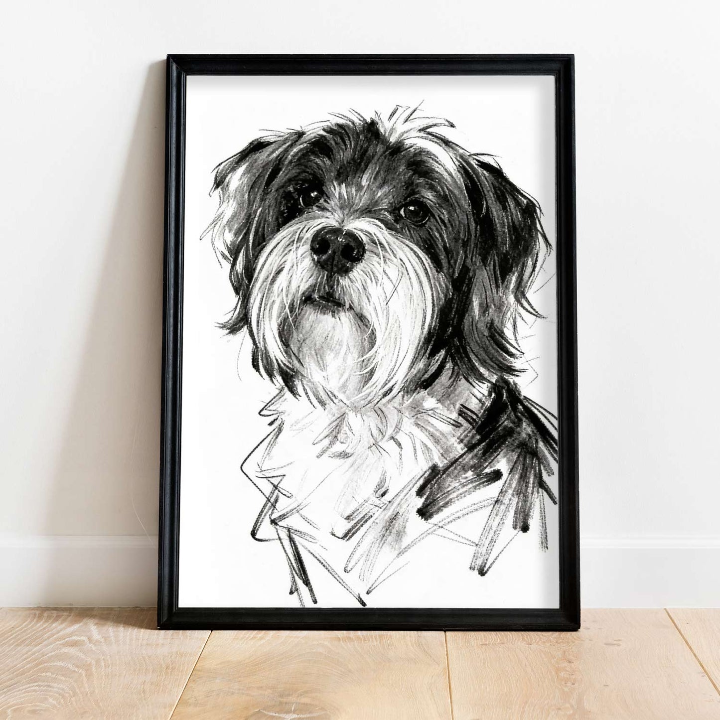 Single sketch style dog portrait in black frame leaning against wall