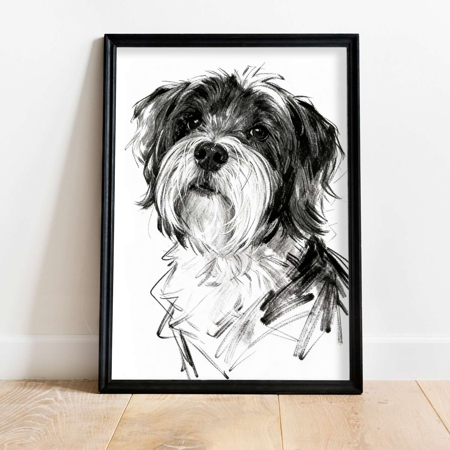 Single sketch style dog portrait in black frame leaning against wall