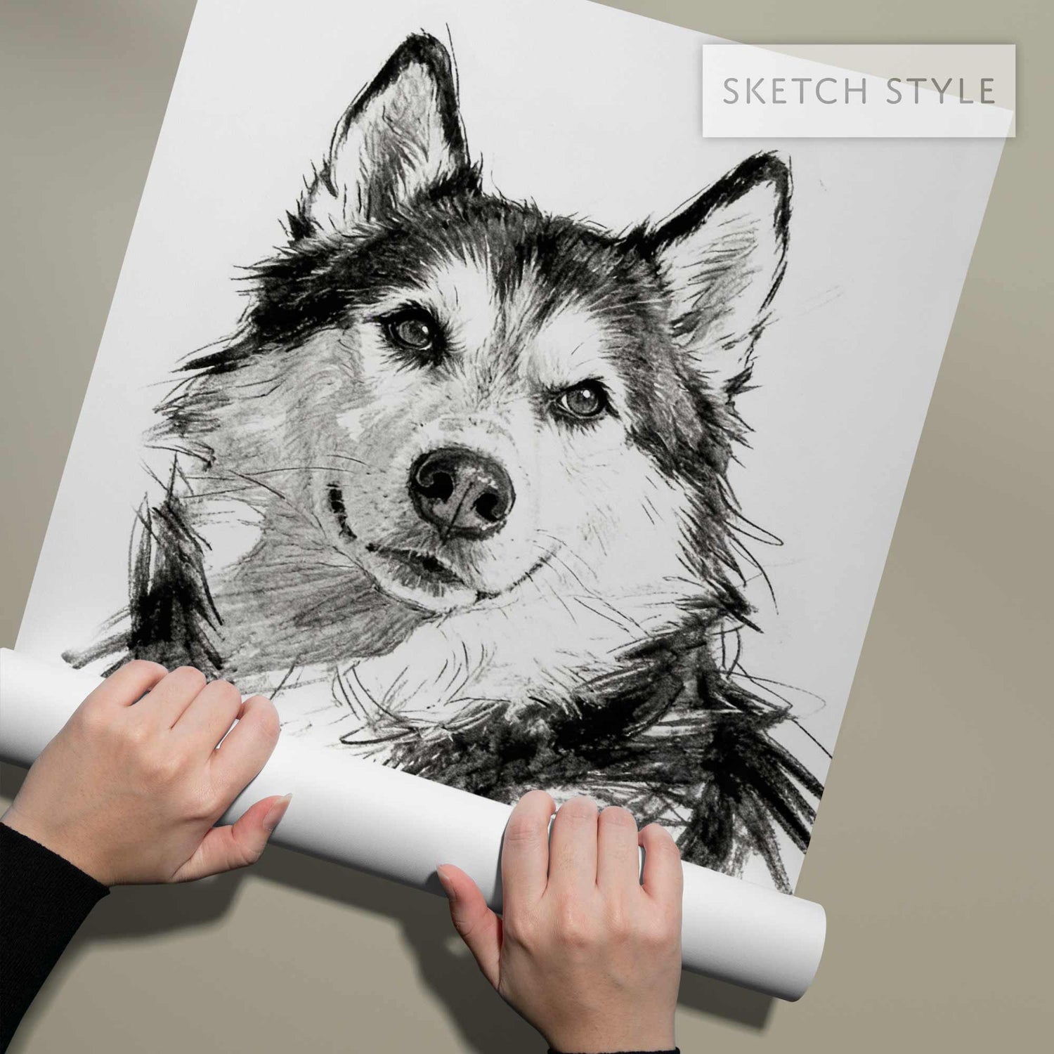 Hands holding rolled sketch style pet portrait print close up