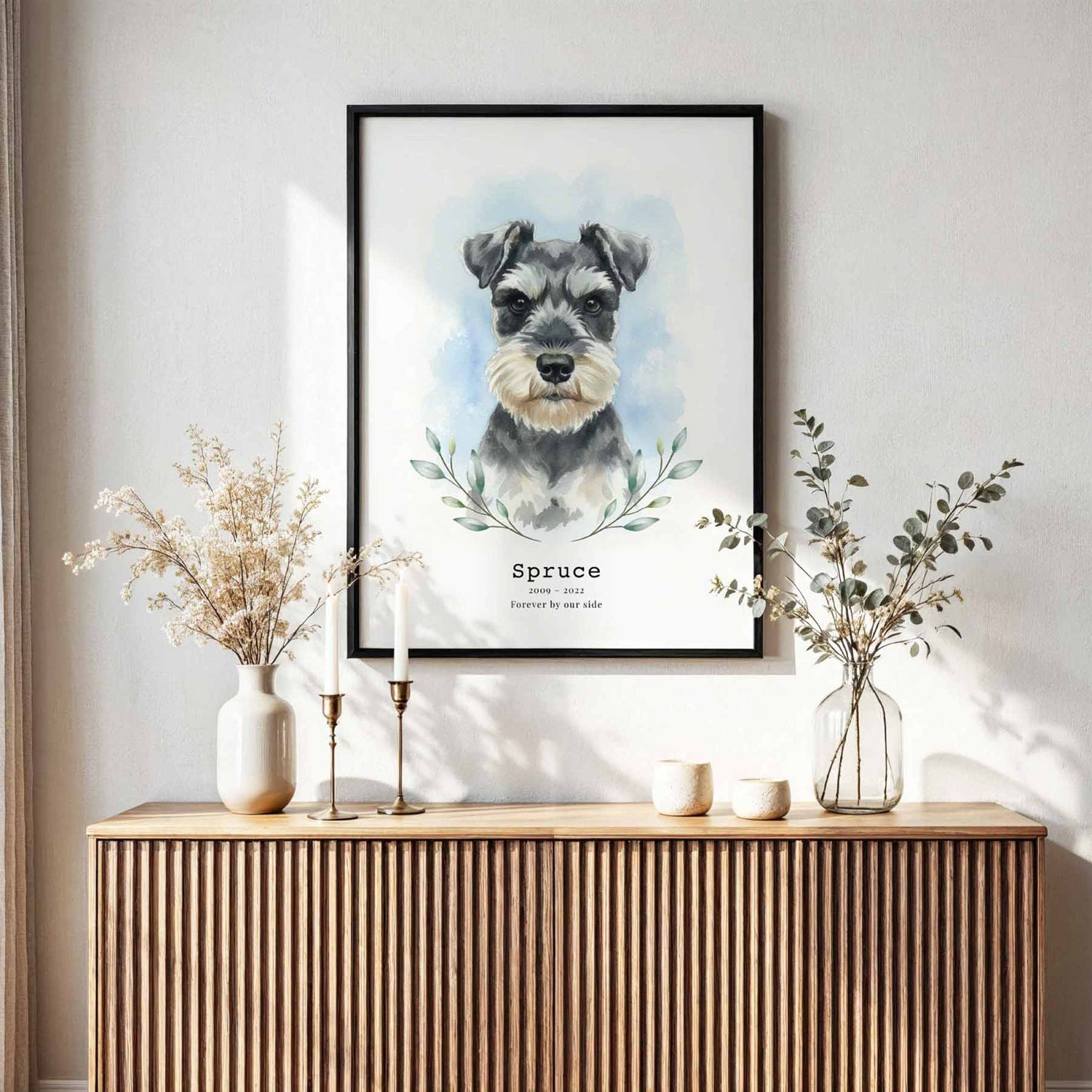 Framed artwork of a dog's portrait on a wall above a wooden console table with decorative items.