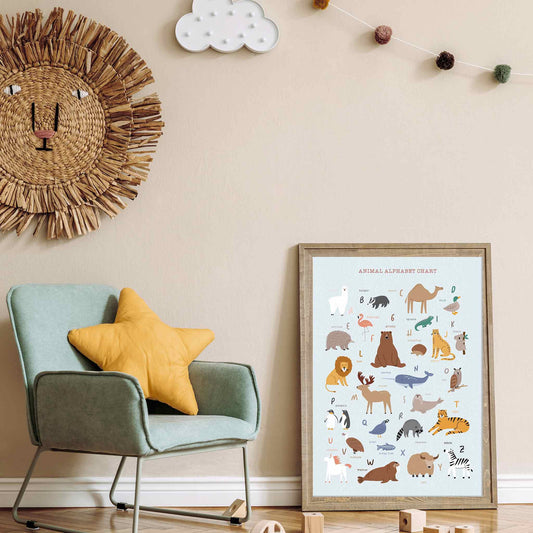 An oak picture frame of a cute Scandinavian animal alphabet poster print in a kids room