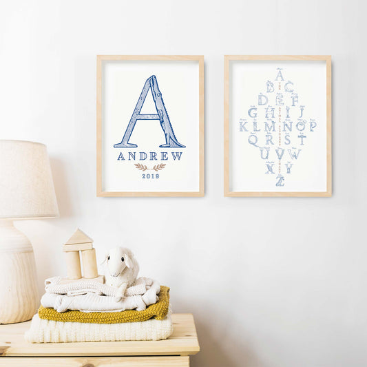 A set of oak picture frames of blue monogram name print and alphabet shape animal chart decorated on the wall of a nursery