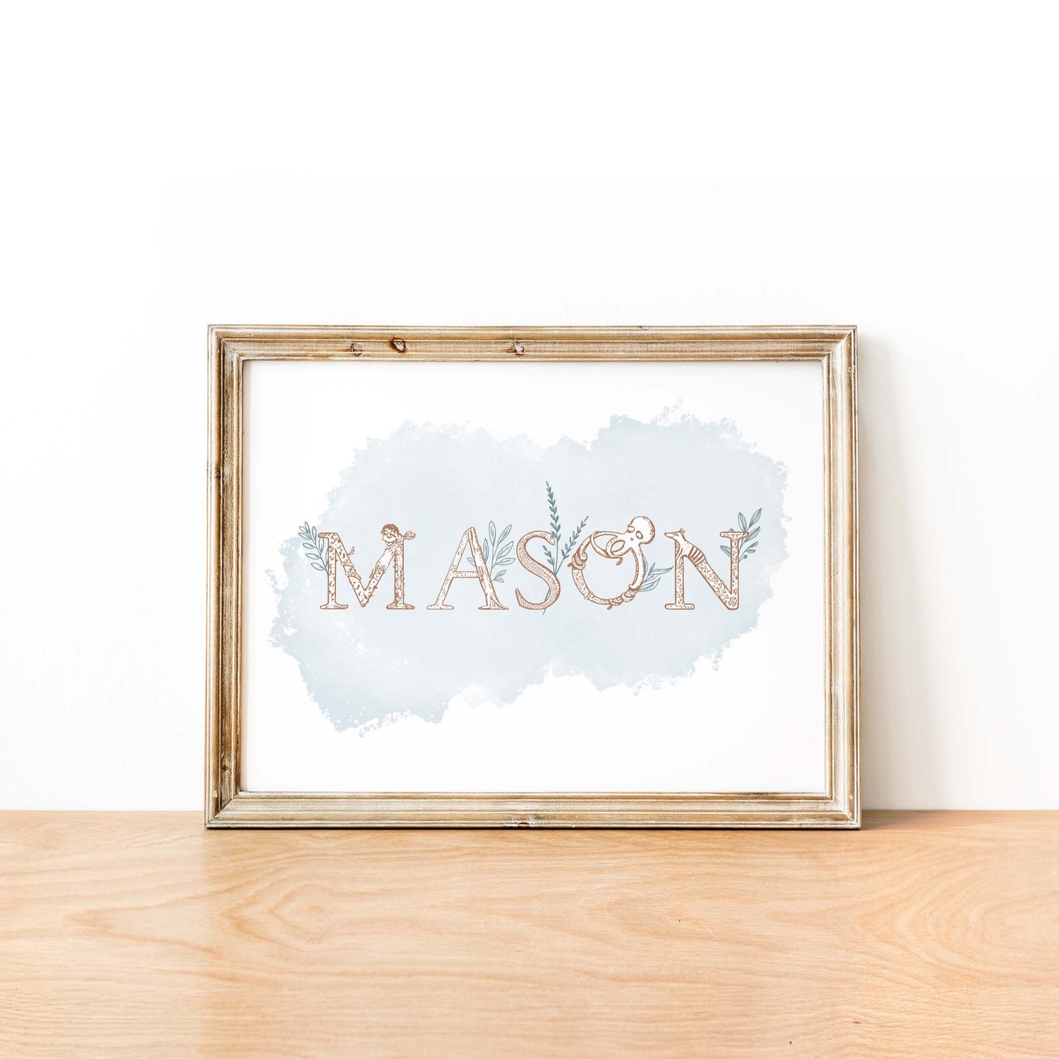 An oak picture frame of a animal alphabet shape name print in blue watercolour background 