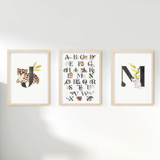 A set of 3 oak picture frames of black monogram prints and alphabet shape animal chart