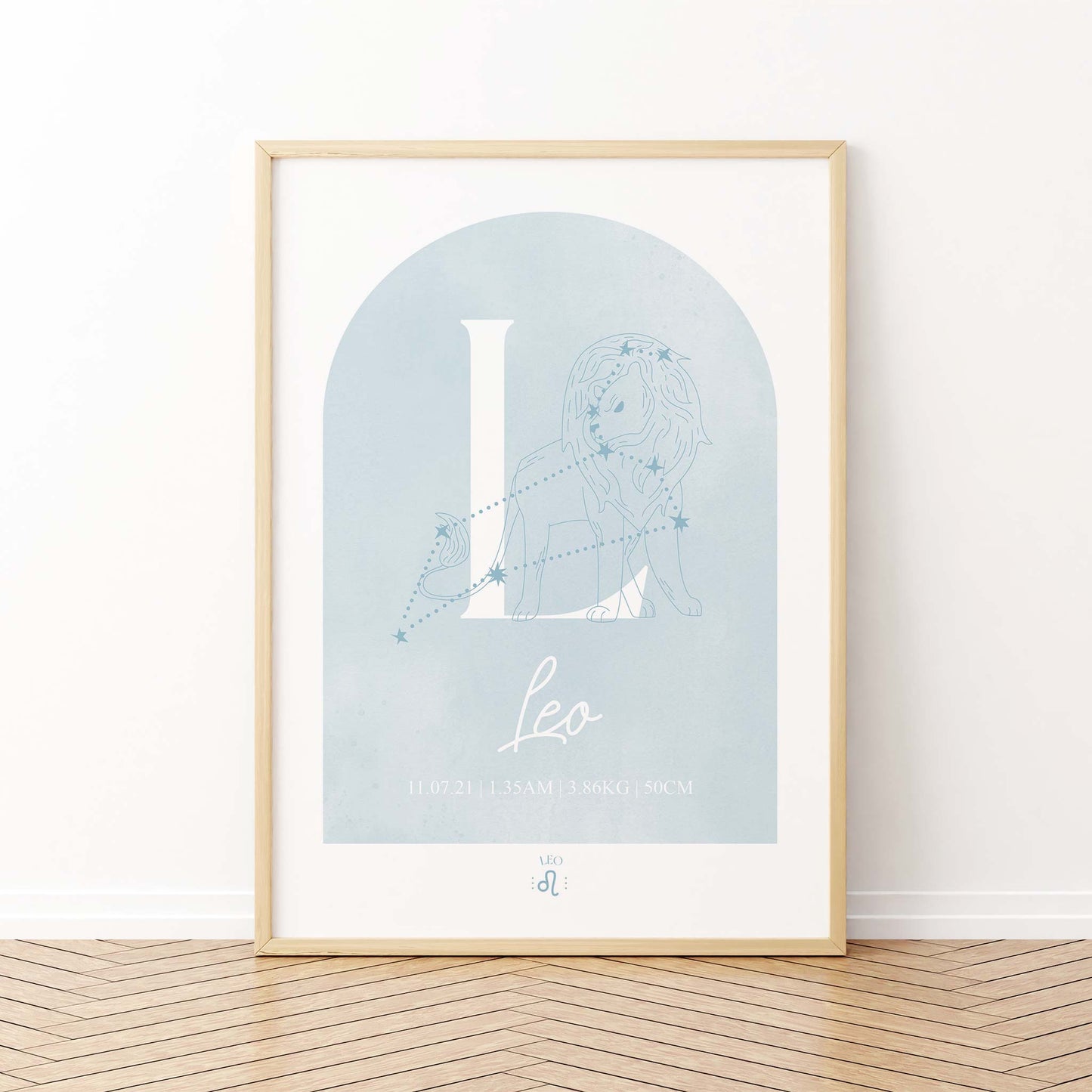 A framed oak frame of a blue watercolor arch display personalised horoscope birth print with Zodiac symbol and constellation