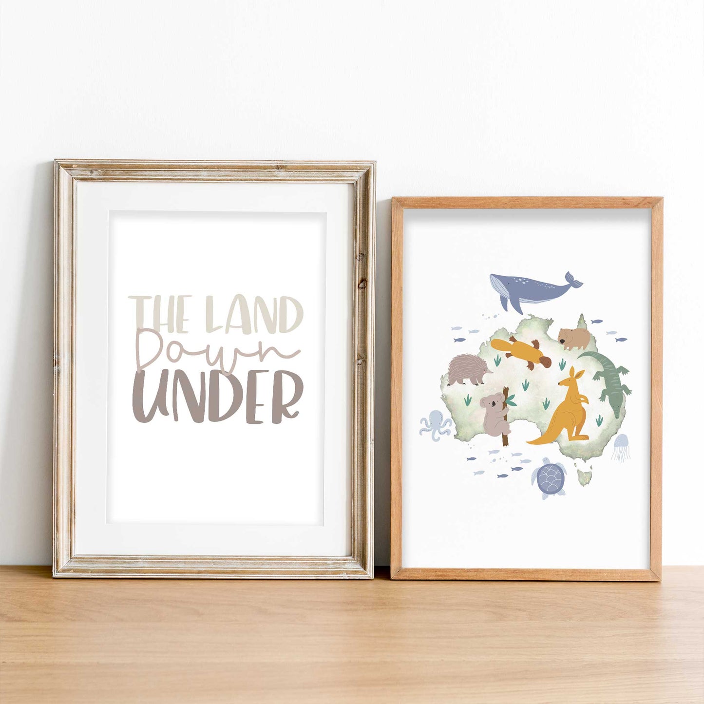 Two framed wooden frames of the land down under print and Australia animal map print