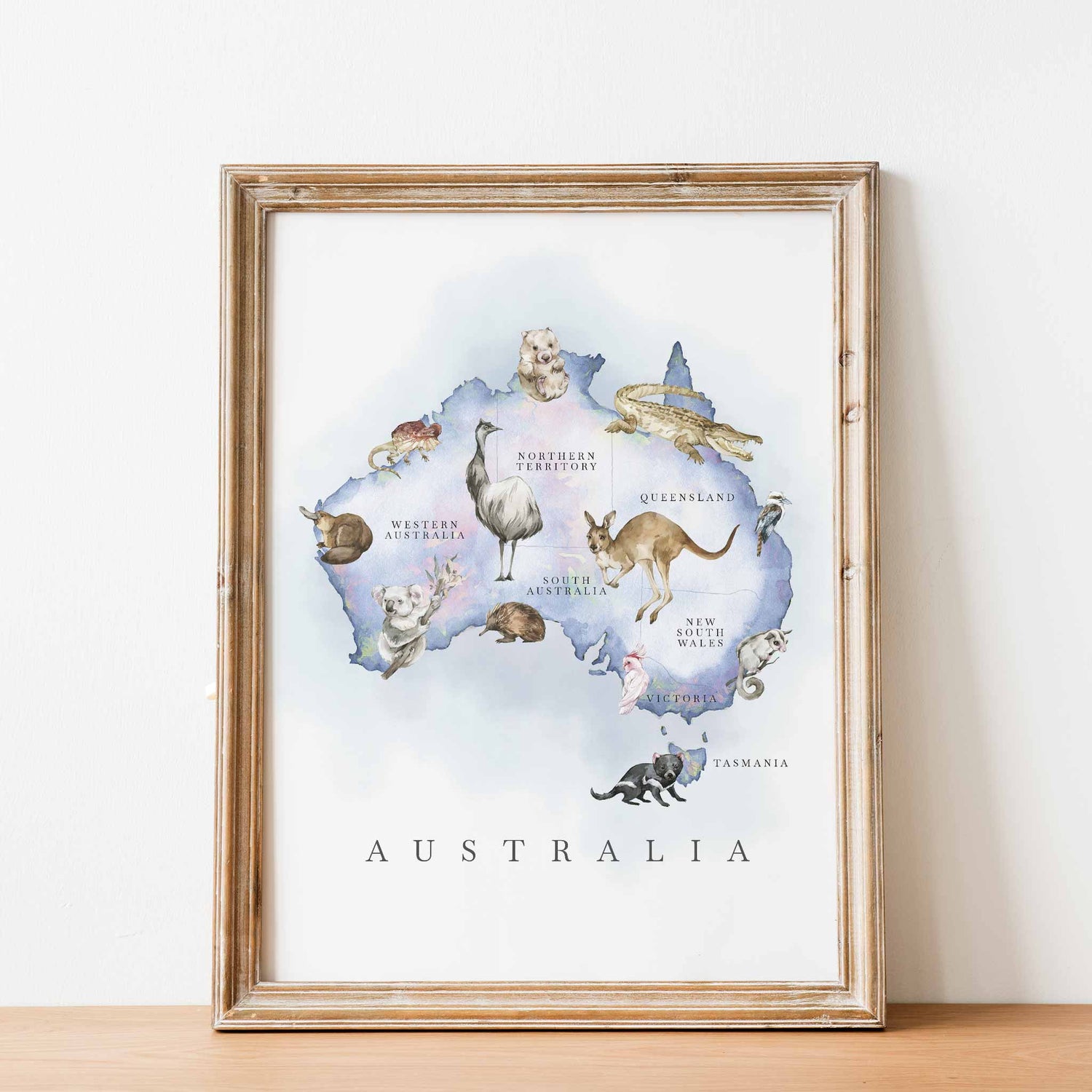 An oak framed image of Australia map featuring Australian native animals in an opal finish