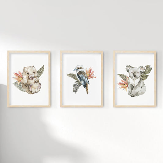 A set of 3 framed oak frames displaying kids nursery wall prints of Australian wombat, kookaburra and koala on tropical floral background