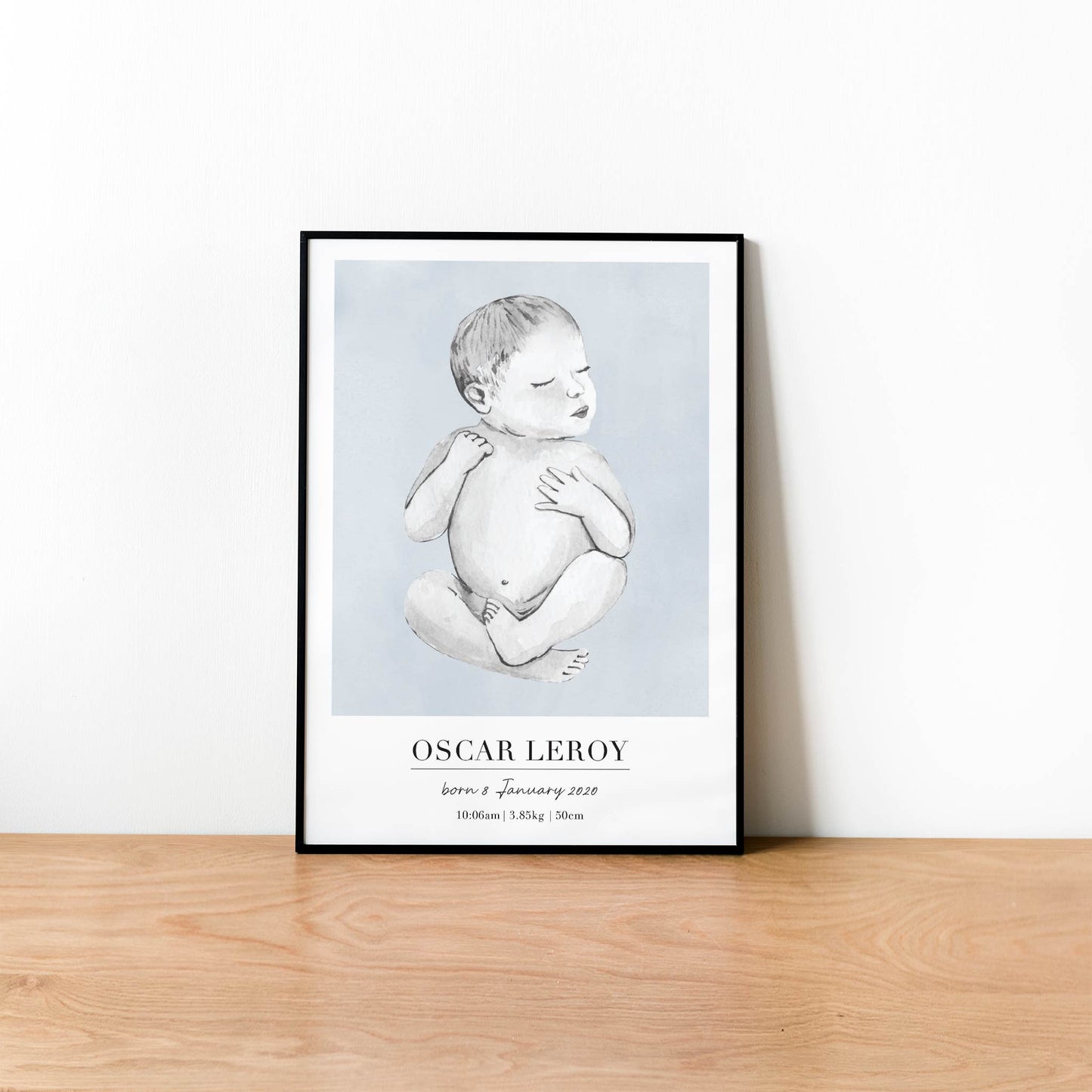 A black picture frame of a baby boy personalised birth poster print