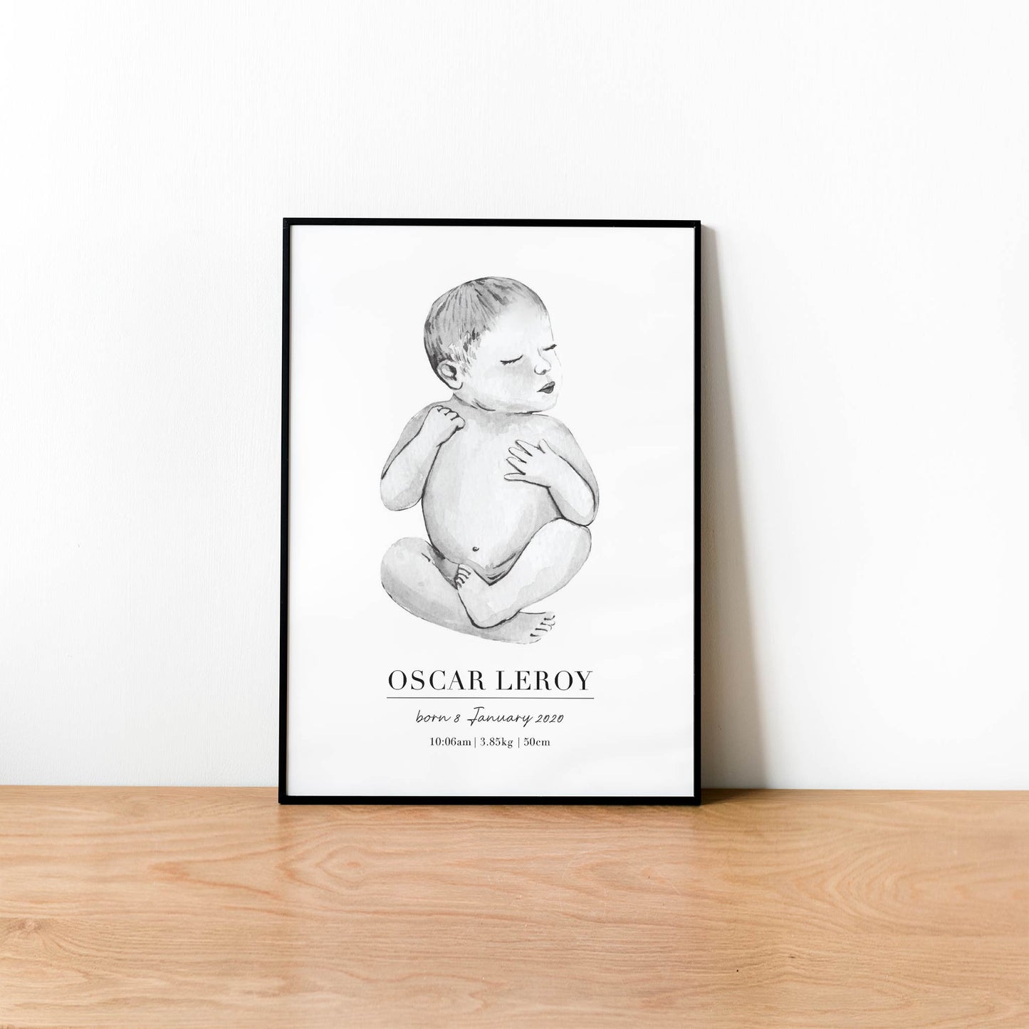 A black picture frame of a baby boy personalised birth poster print