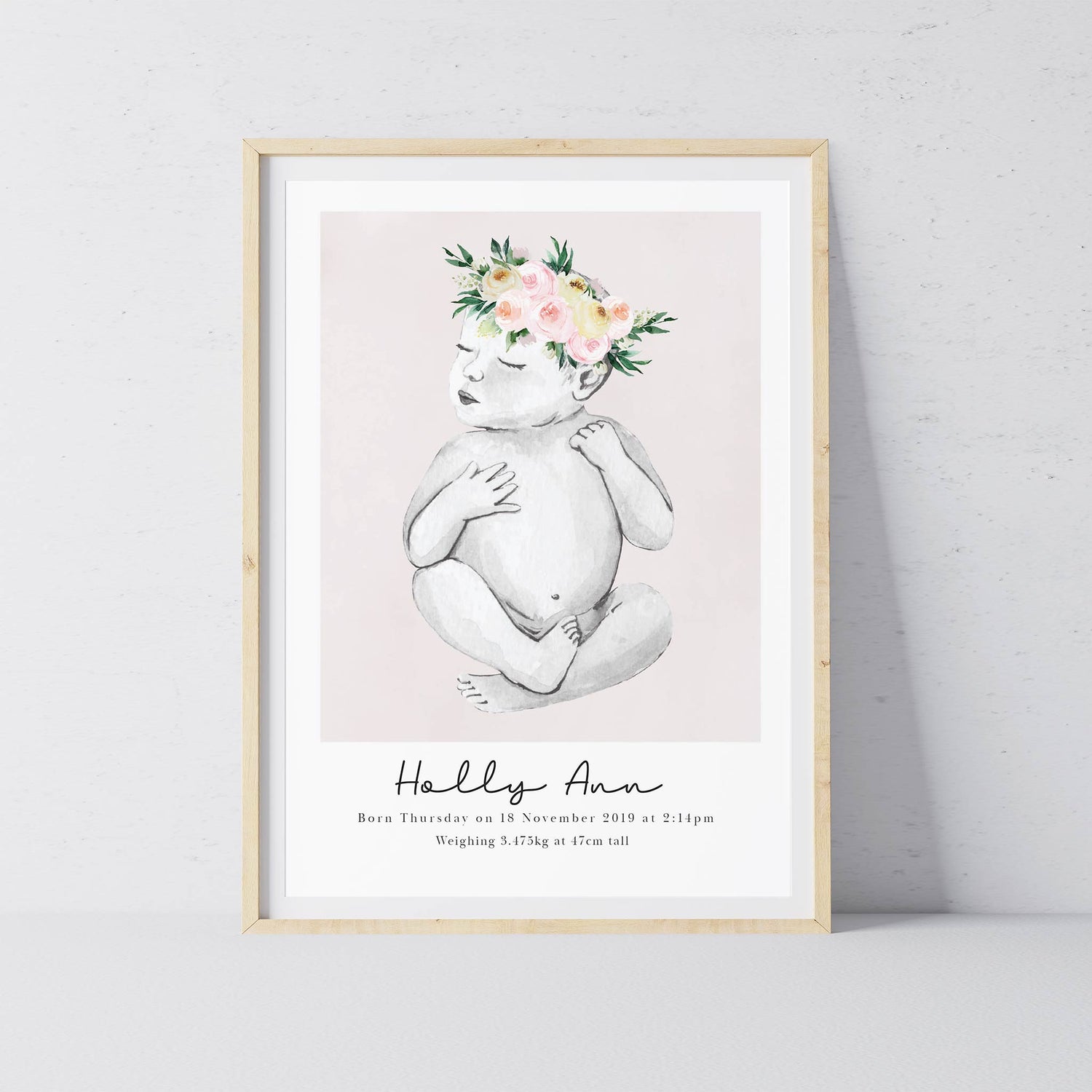 An oak picture frame of a baby girl personalised birth poster print 