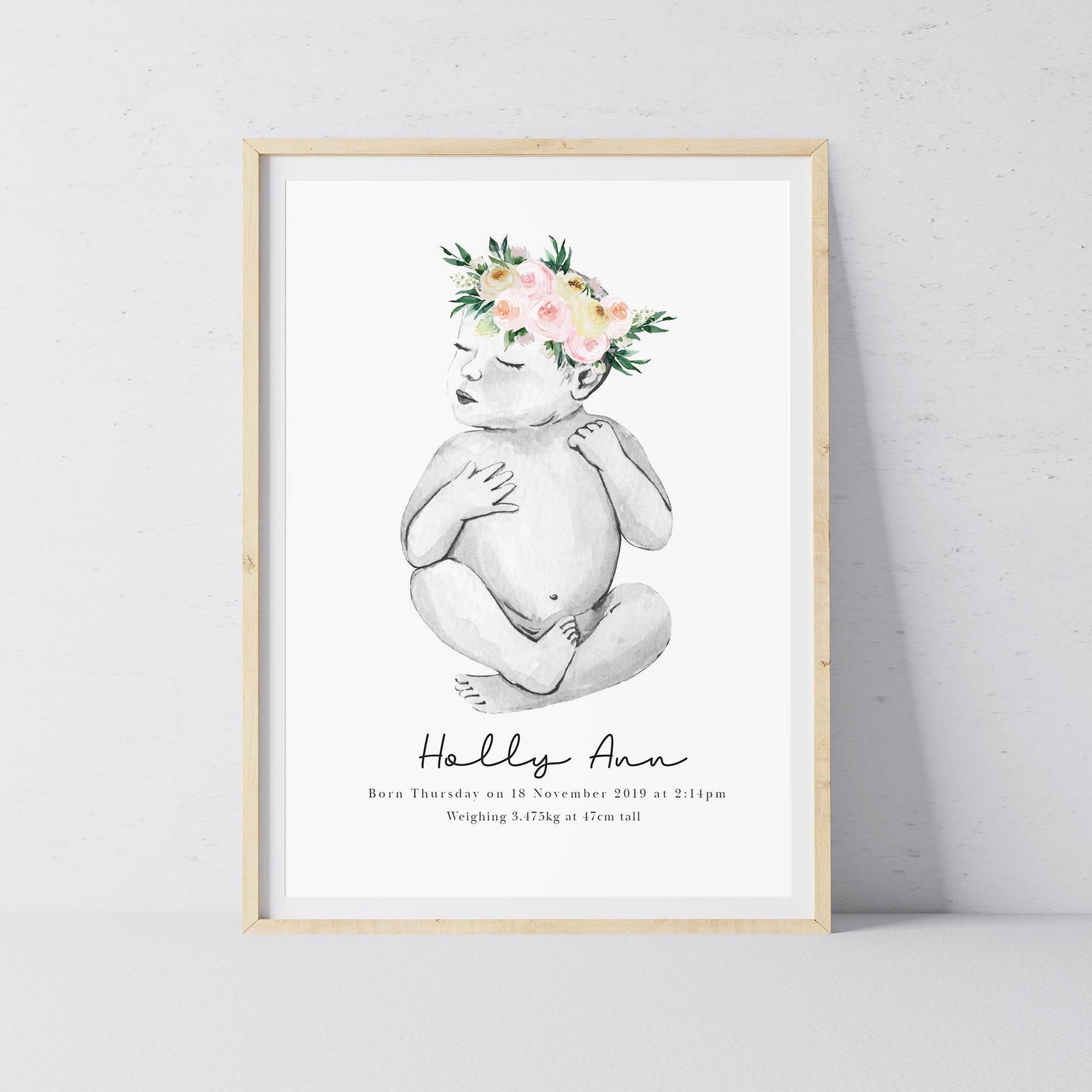 An oak picture frame of a baby girl personalised birth poster print