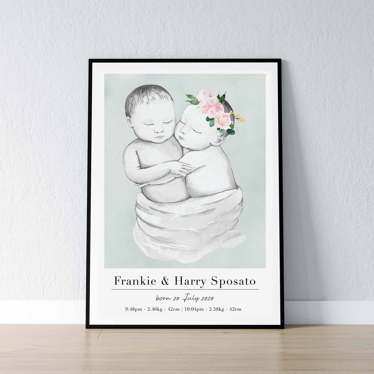 A black picture frame of a baby twin boy and girl personalised birth poster print