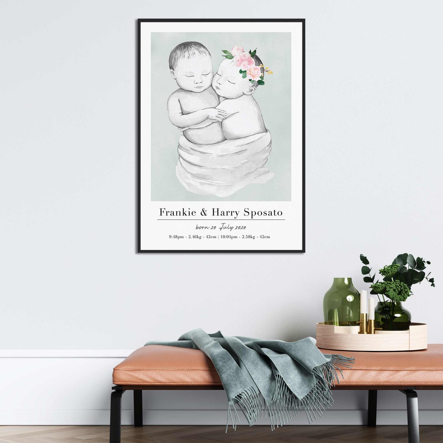 A black picture frame of a baby twin boy and girl personalised birth poster print decorated in a living room