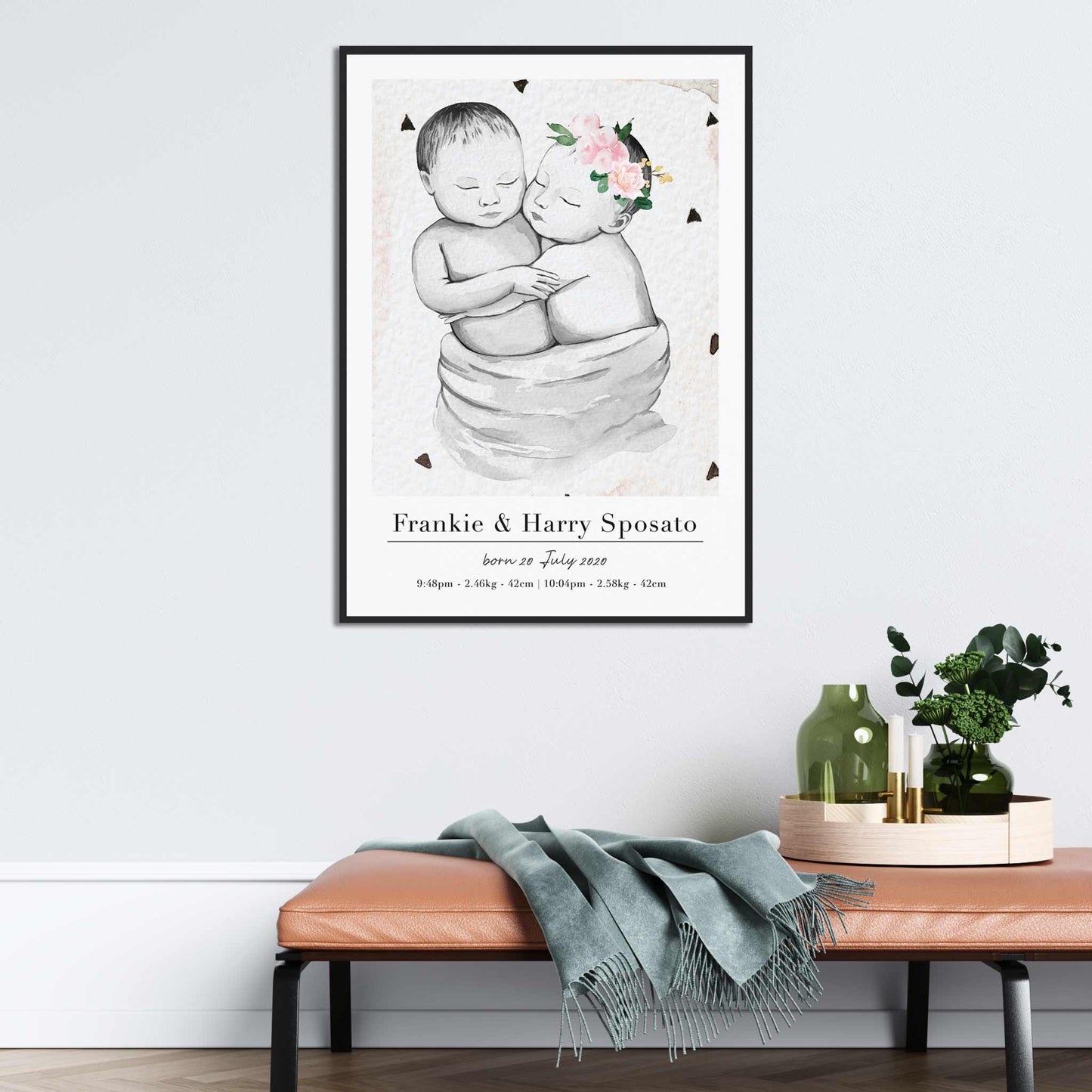 A black picture frame of a baby twin boy and girl personalised birth poster print decorated in a living room