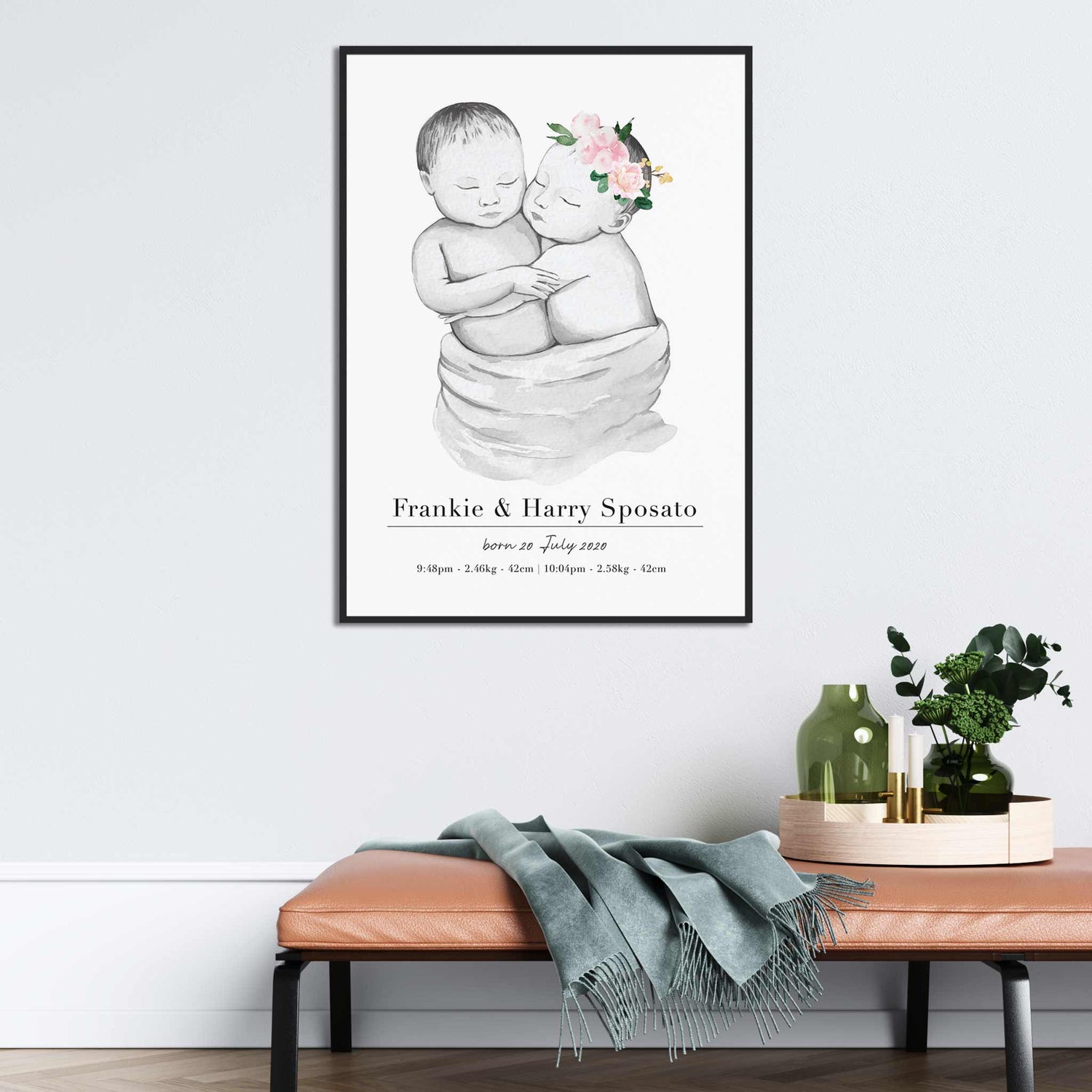 A black picture frame of a baby twin boy and girl personalised birth poster print decorated in a living room