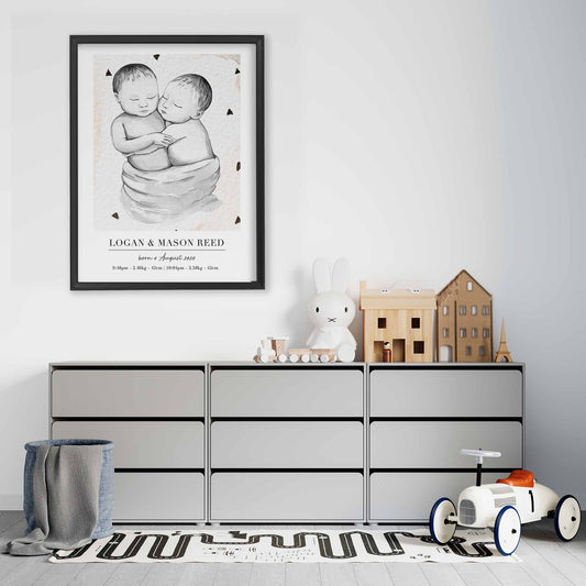 A black picture frame of a baby twin boys personalised birth poster print decorated in a living room