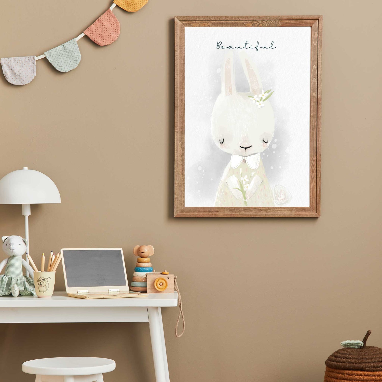 An oak frame of a cute whimsical bunny rabbit with inspirational quote decorated in a kids room