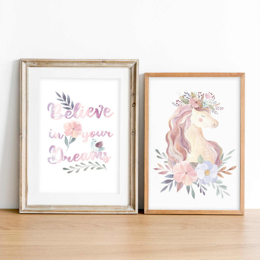 A set of 2 wooden picture frames of an aspirational quote believe in your dreams and unicorn floral print