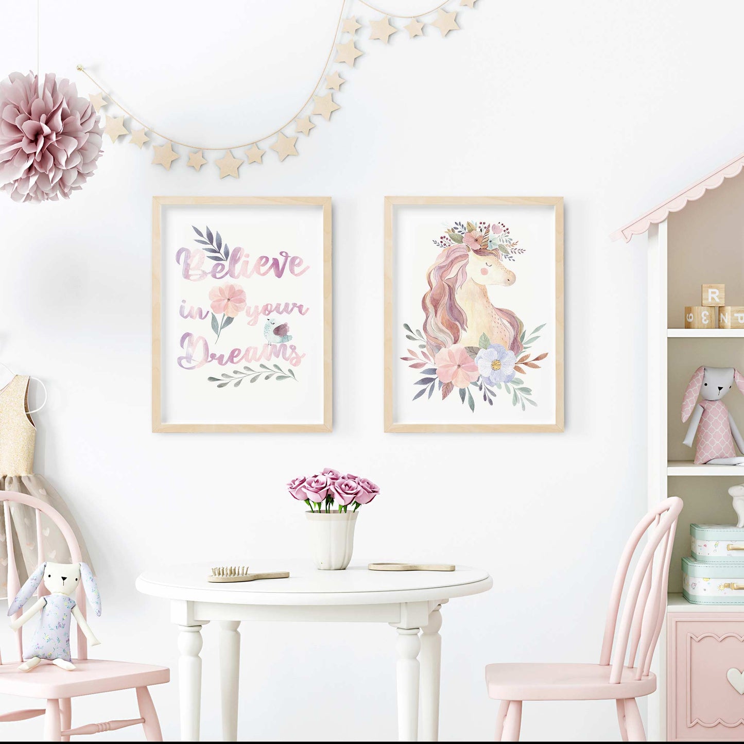 A set of 2 wooden picture frames of an aspirational quote believe in your dreams and unicorn floral print decorated in a nursery