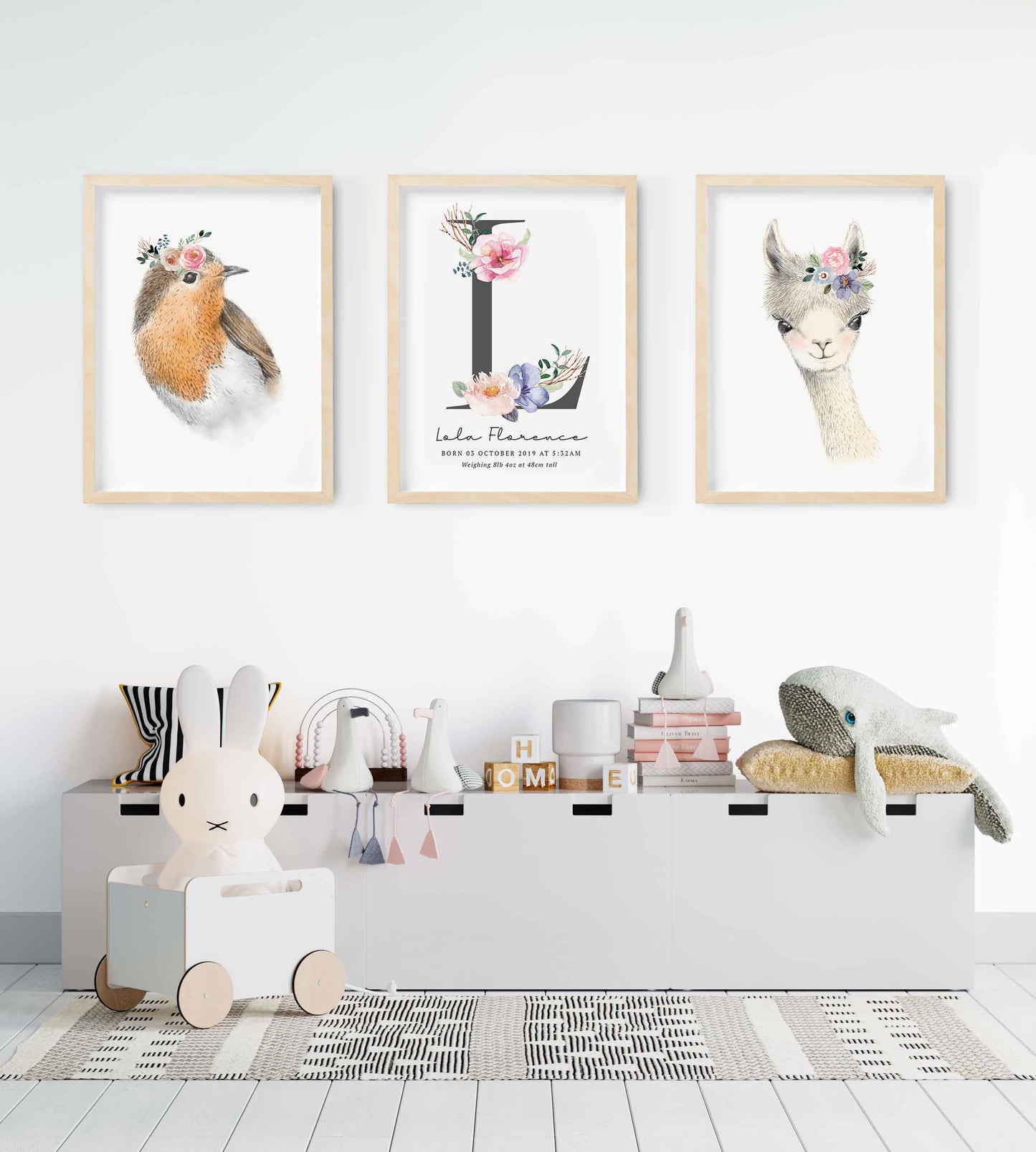 A set of 3 framed images of woodland bird and llama floral monogram nursery personalised birth print decorated in a nursery