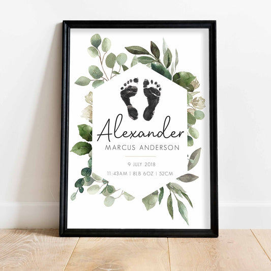 A black picture frame of a botanical baby personalised keepsake footprints birth print 