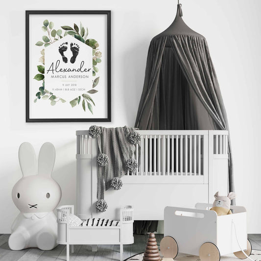 A black picture frame of a botanical baby personalised keepsake footprints birth print decorated in a nursery