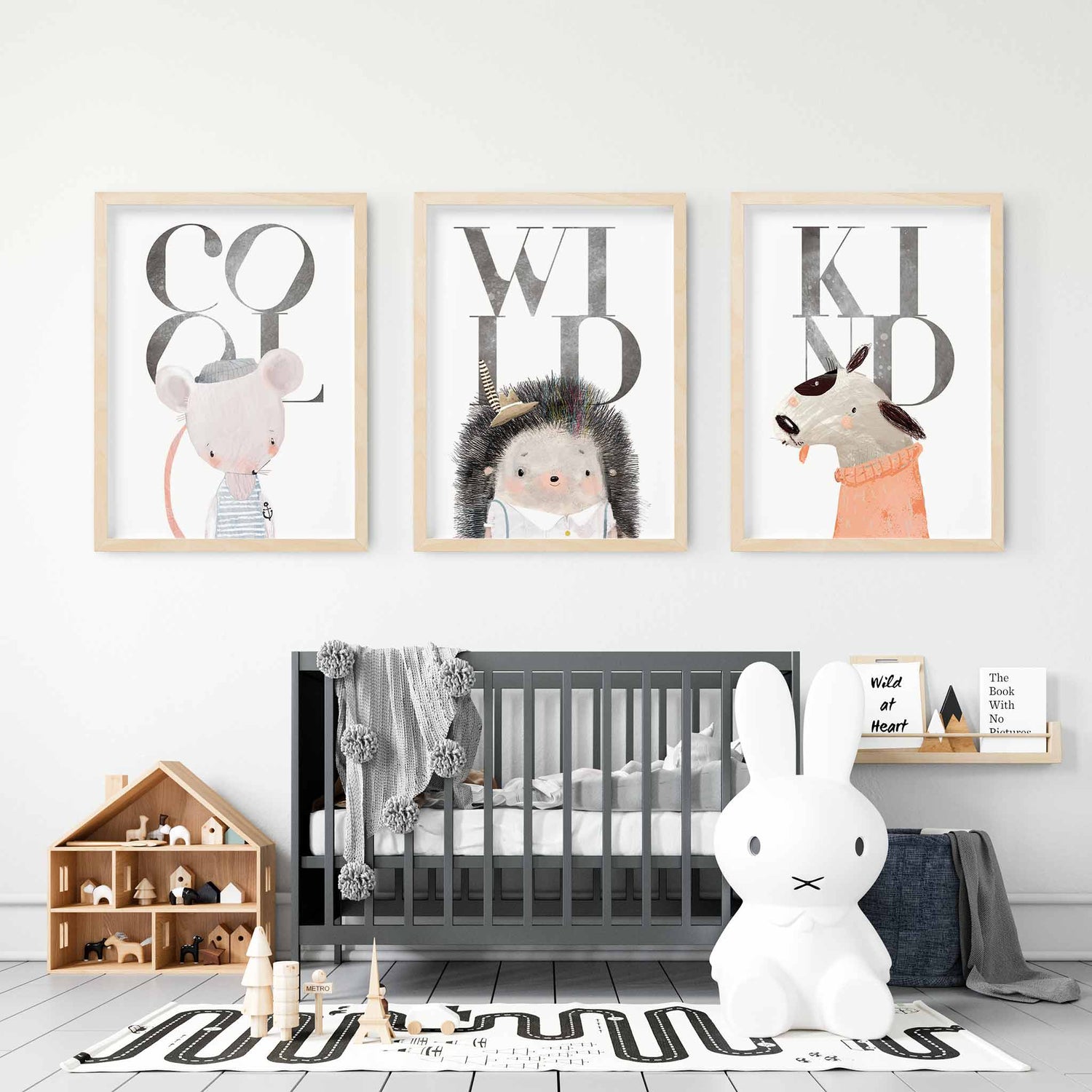 A set of 3 oak frames of a mouse, hedgehog and dog inspirational quotes kids prints decorated in a nursery room