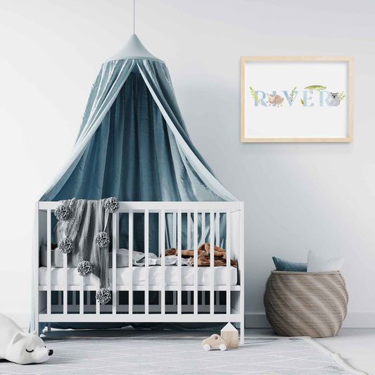 An oak picture frame of a cute animals kids personalised name print decorated in a nursery