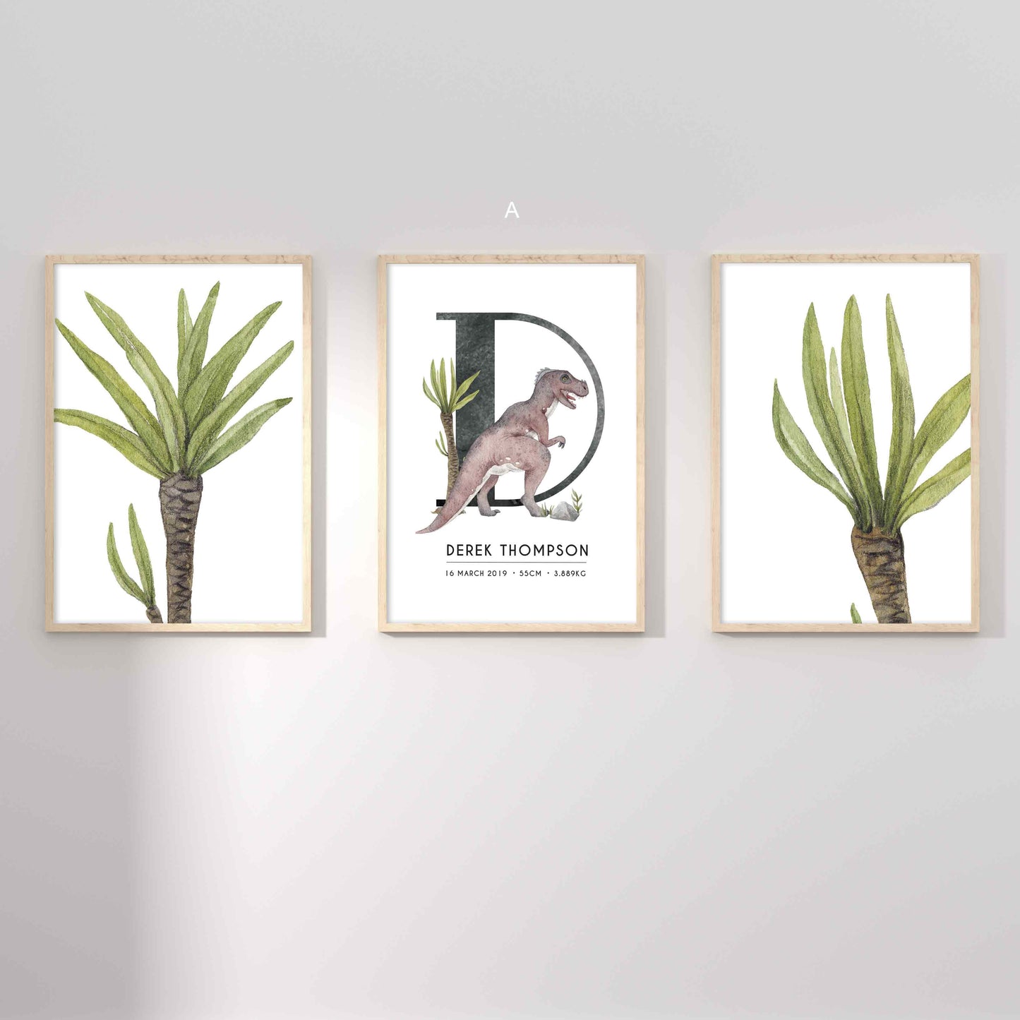 A set of 3 framed oak frames displaying kids nursery wall prints of palm trees and a dinosaur personalised monogram birth print