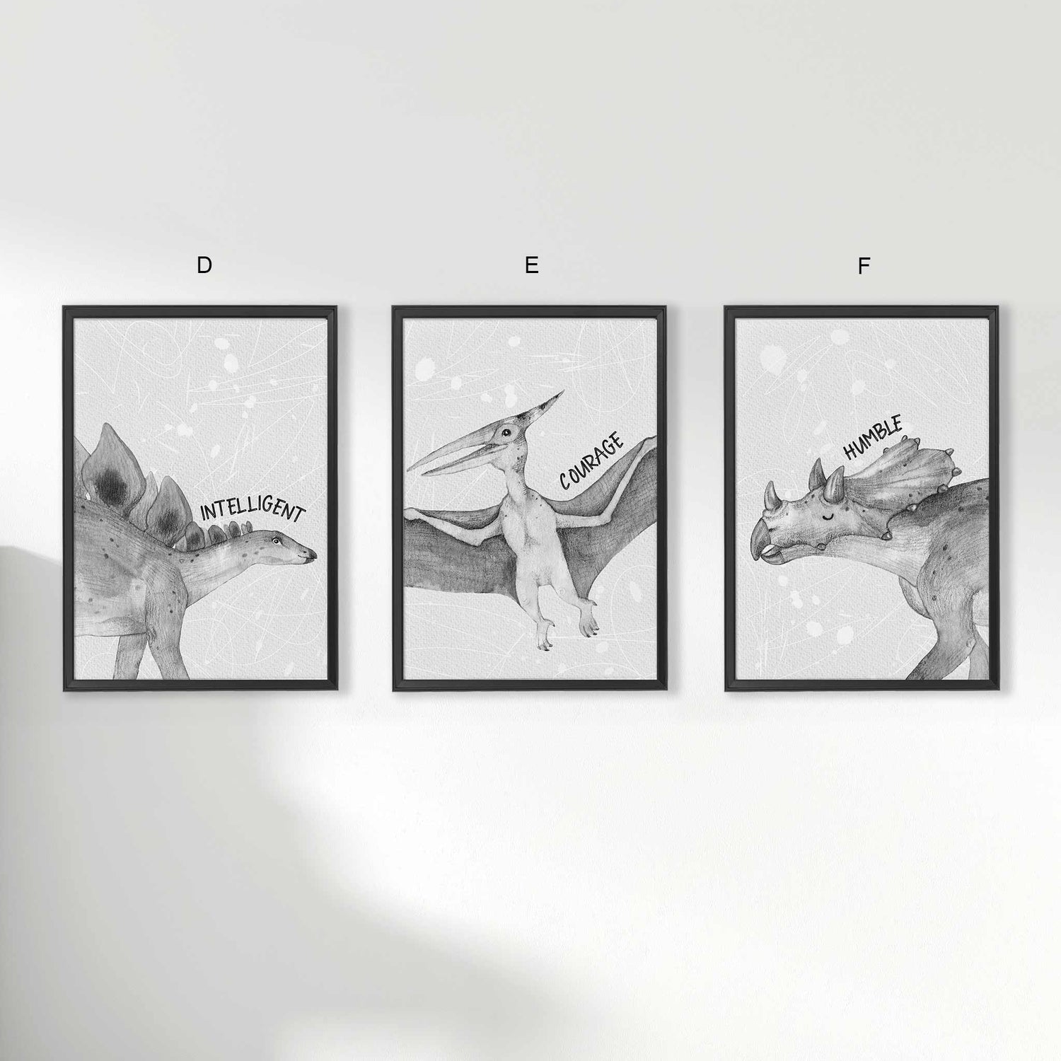 A set of 3 framed black frames displaying kids nursery aspirational wall prints of dinosaur monochromatic sketched art