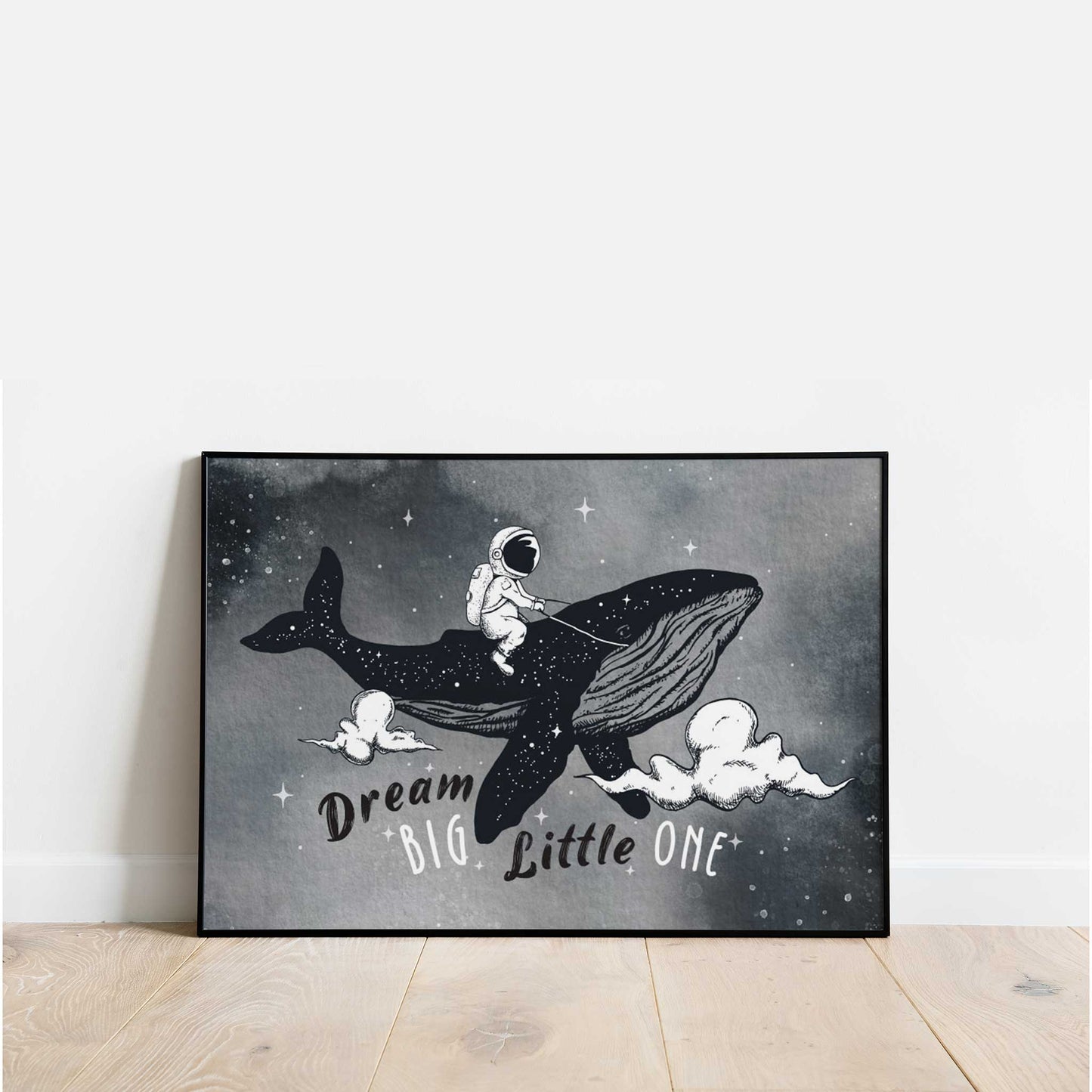 A black frame picture of a kids space aspirational poster print featuring an astronaut riding a whale in the night sky