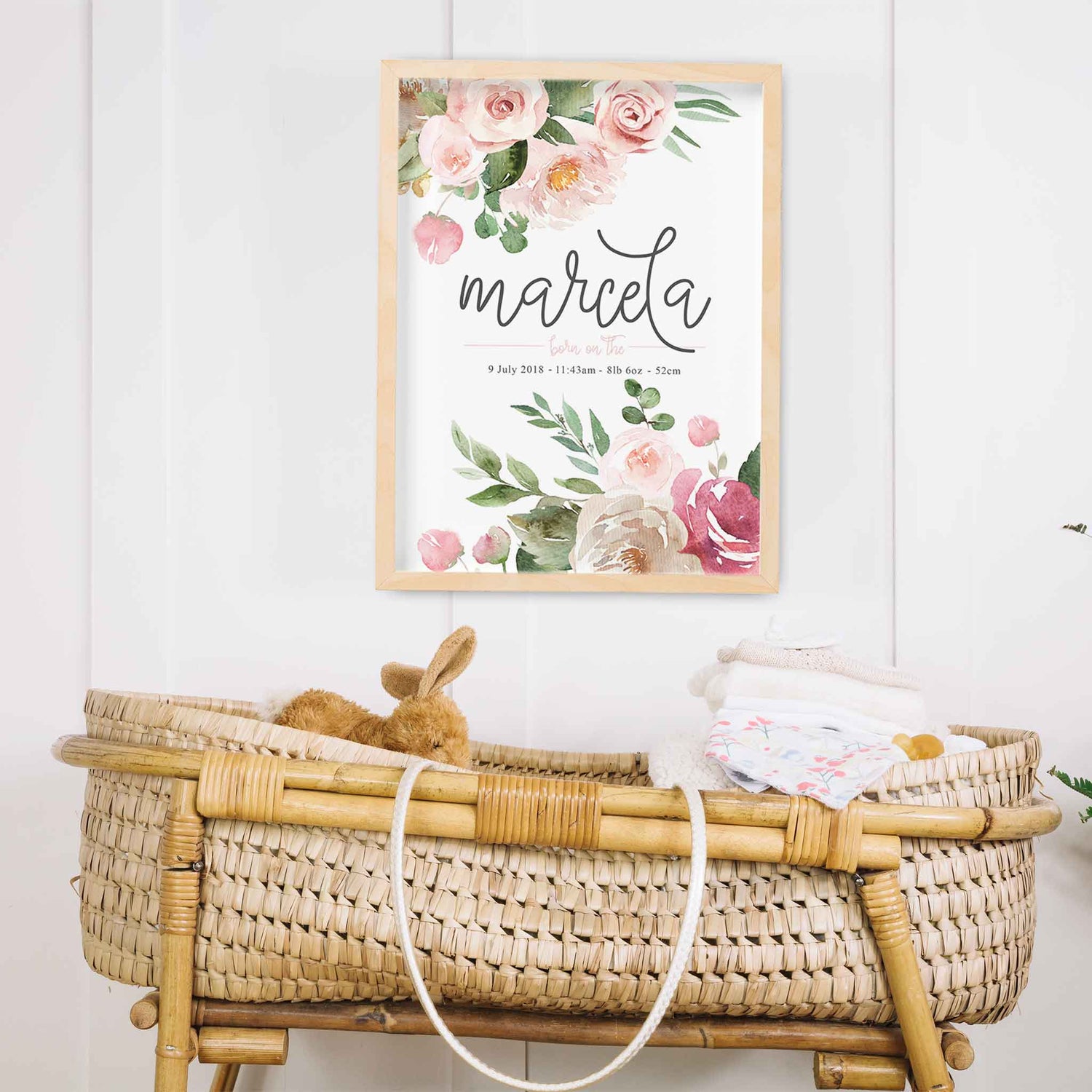 An oak frame of floral boho pink roses nursery personalised birth print decorated in a nursery