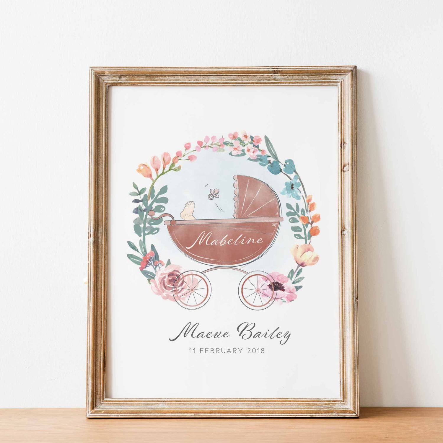 An oak picture frame of a floral wreath baby pram personalised birth print 