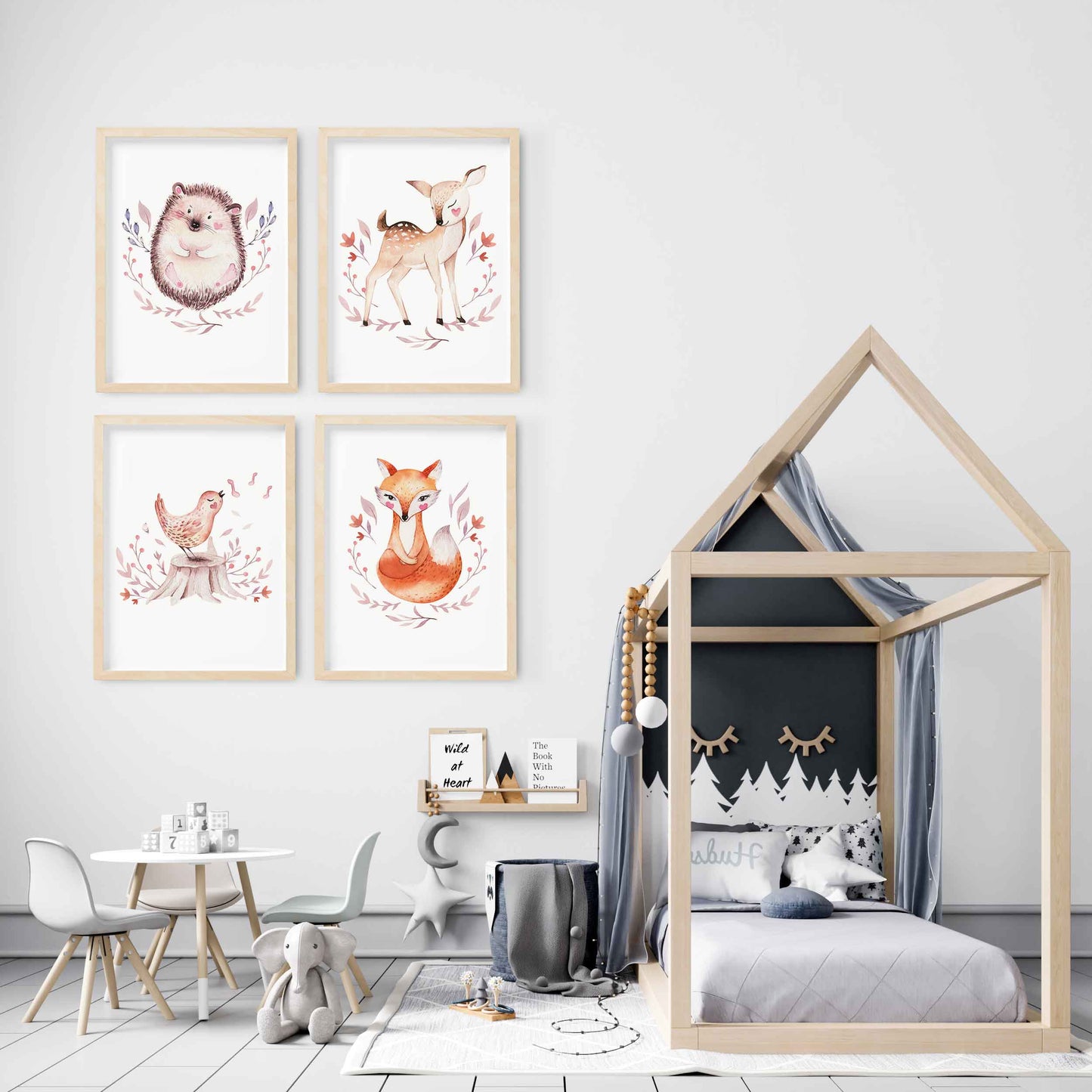 A set of 4 framed oak frames displaying woodland hedgehog, deer, bird and fox nursery prints decorated in a kids room