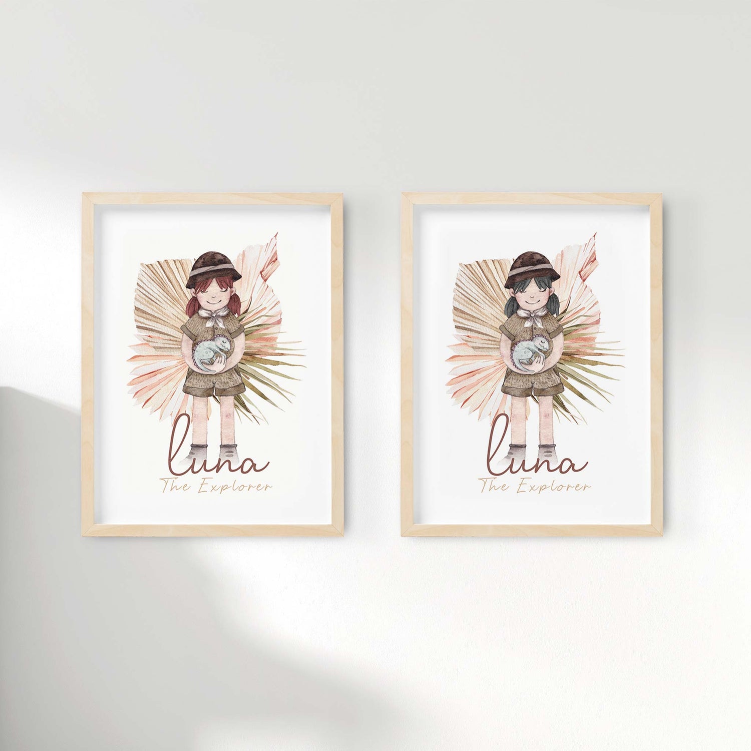 A set of 2 picture frames displaying kids name print of a little girl holding a baby dinosaur