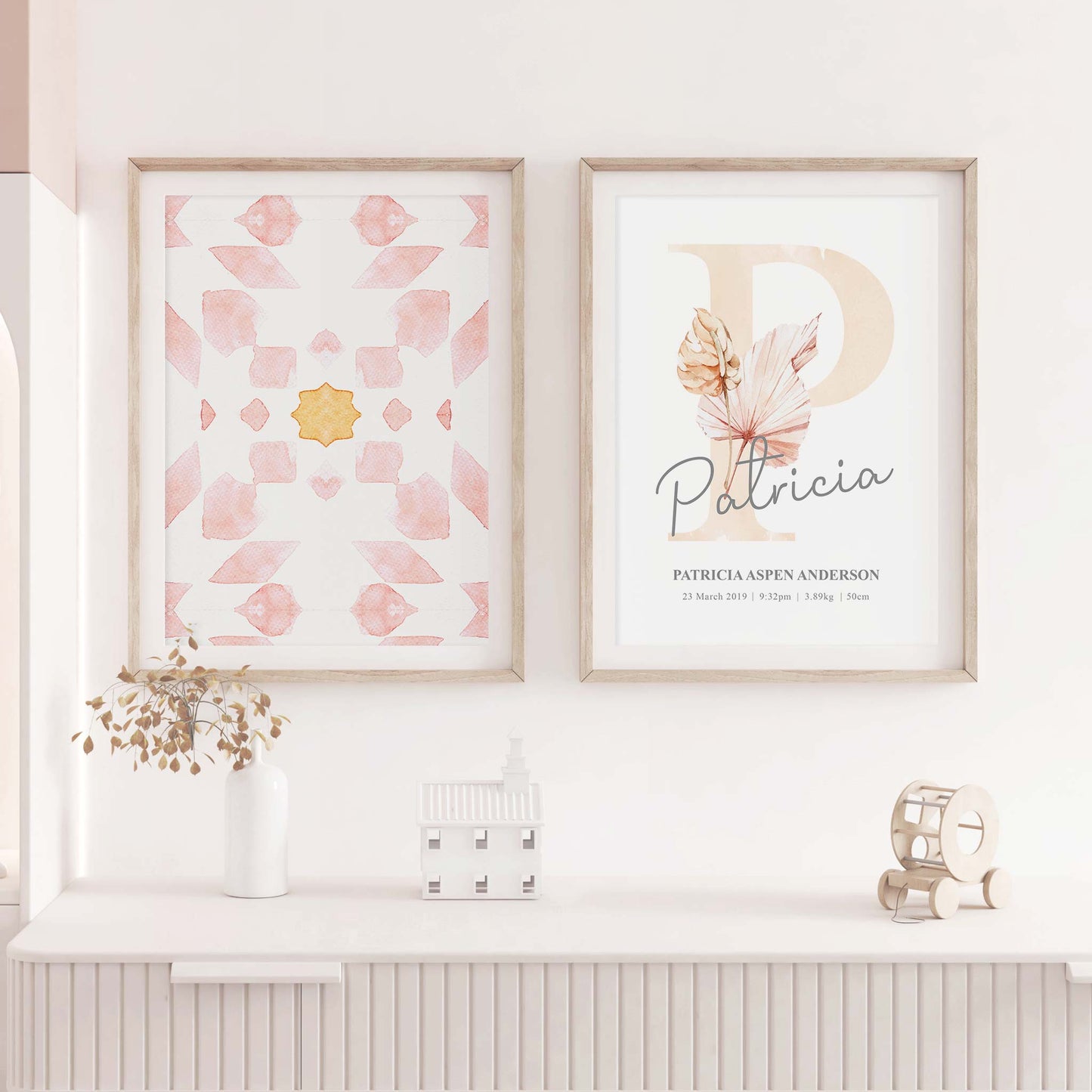 A set of 2 framed images of Moroccan boho floral monogram nursery personalised birth print decorated in a living room