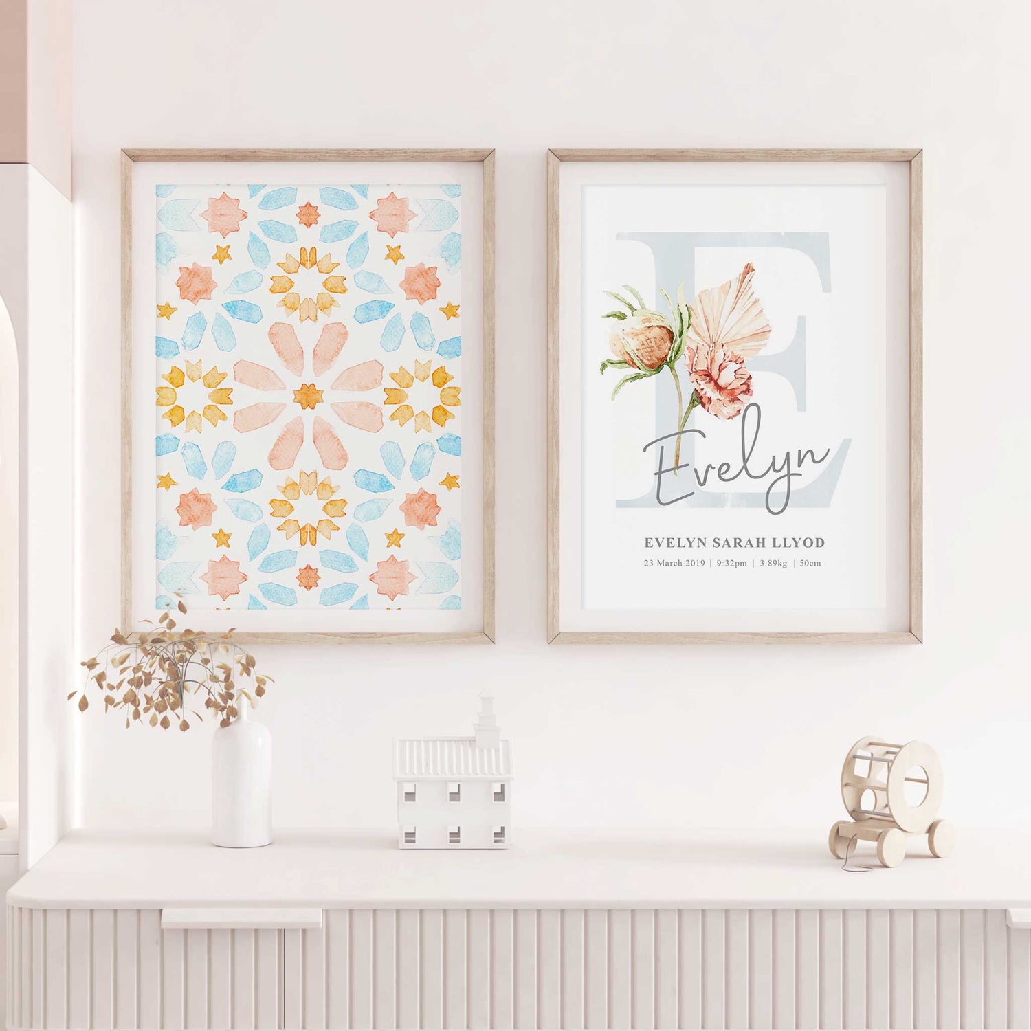 A set of 2 framed images of Moroccan boho floral monogram nursery personalised birth print decorated in a living room 