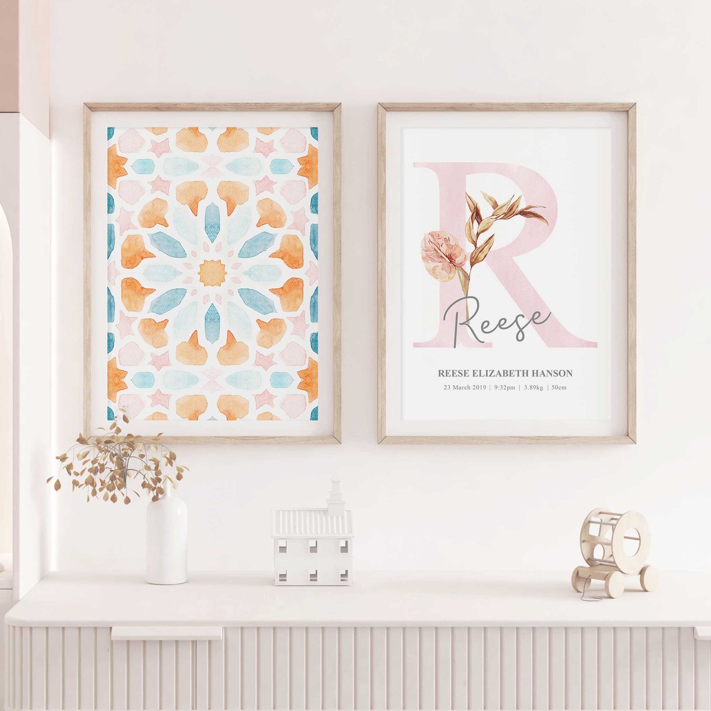 A set of 2 framed images of Moroccan boho floral monogram nursery personalised birth print decorated in a living room