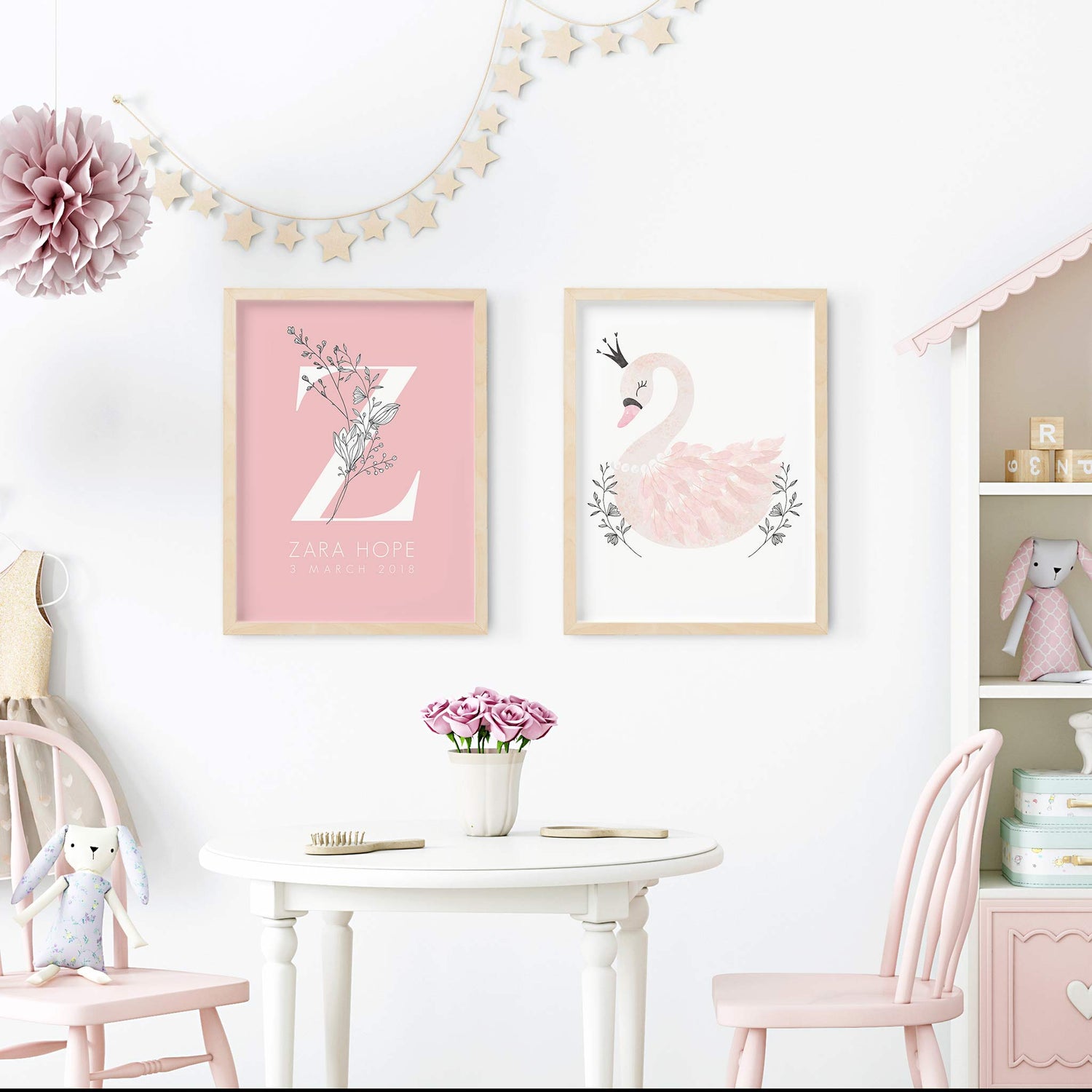 A set of 2 oak picture frames of a beautiful pink princess swan and floral monogram personalised nursery birth print decorated in a girl's room