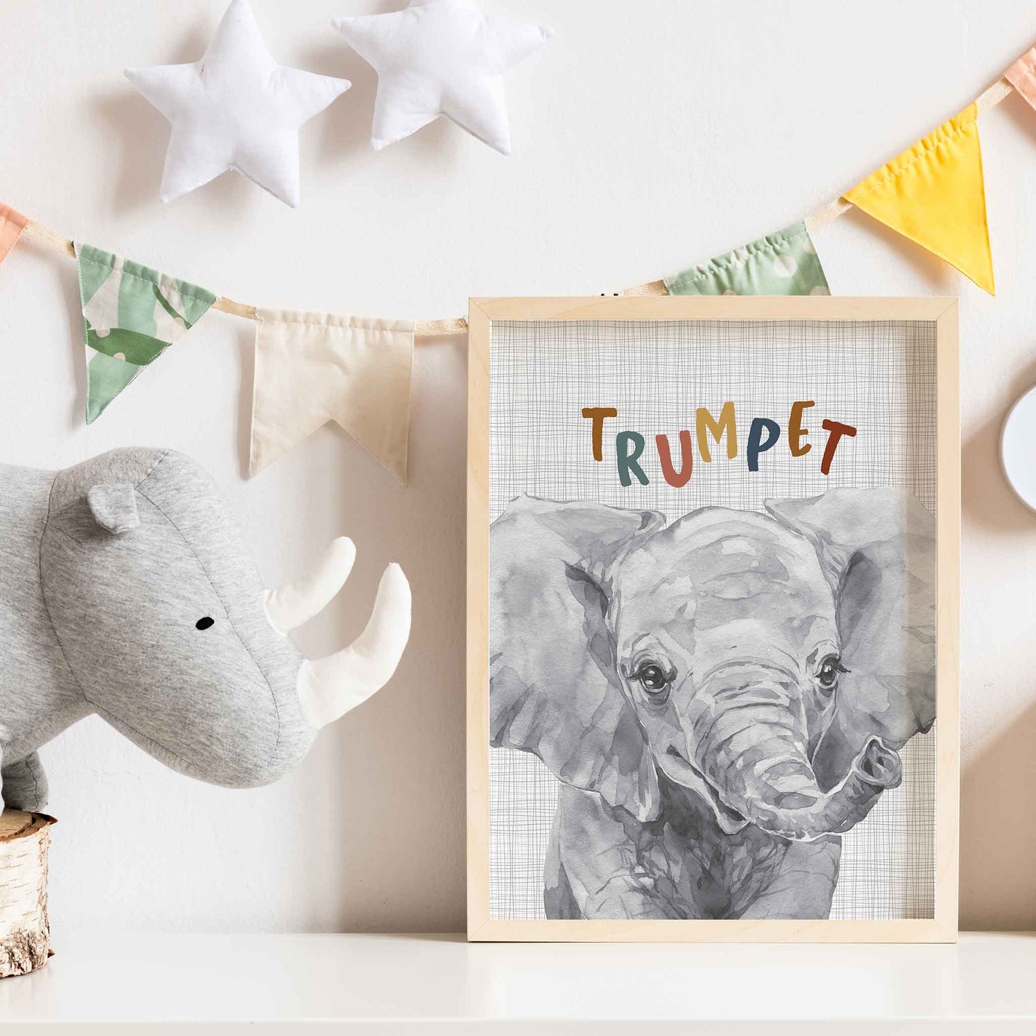 An oak picture frame of a cute watercolour baby elephant decorated in a kids room