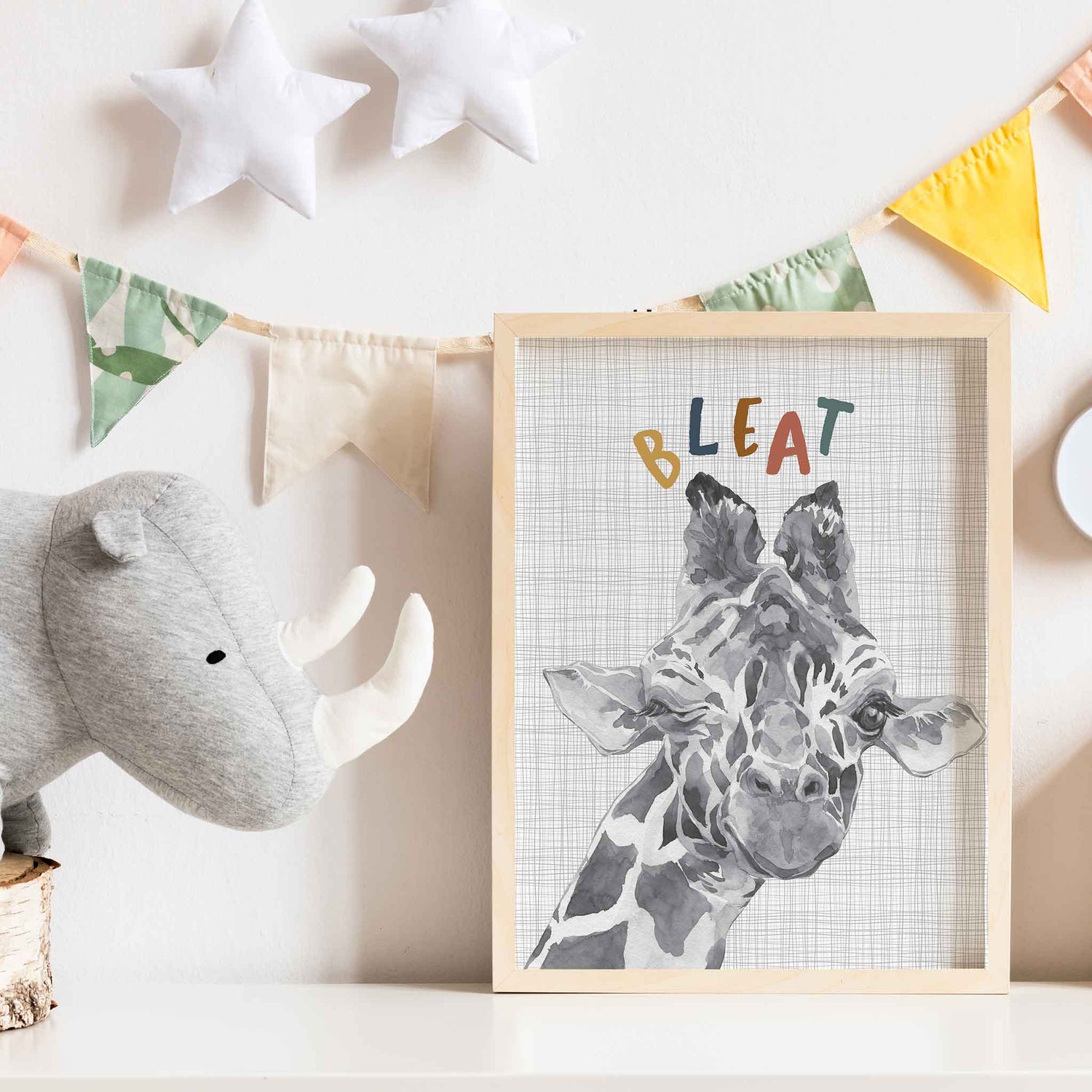 An oak picture frame of a cute watercolour baby giraffe decorated in a kids room