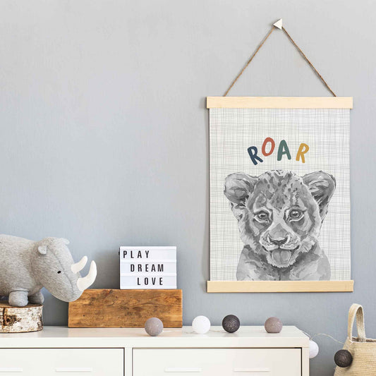 An oak picture frame of a cute watercolour baby lion cub decorated in a kids room