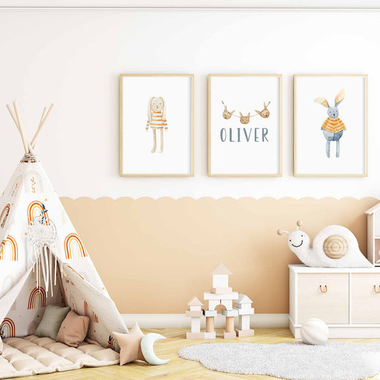 A set of 3 framed oak frames displaying a Scandinavian bunny boys name print decorated in a nursery