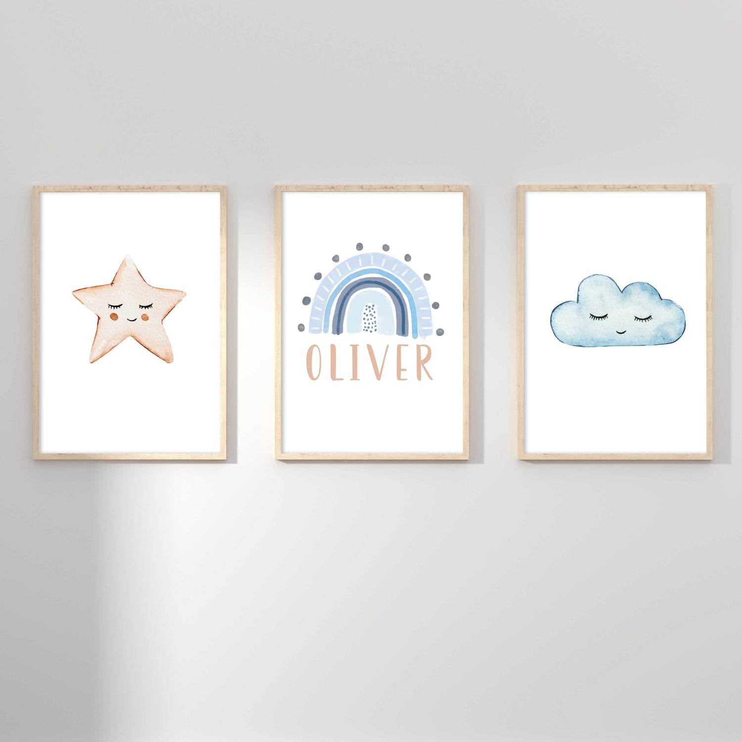 A set of 3 framed oak frames displaying a star, rainbow and cloud boy's name print 