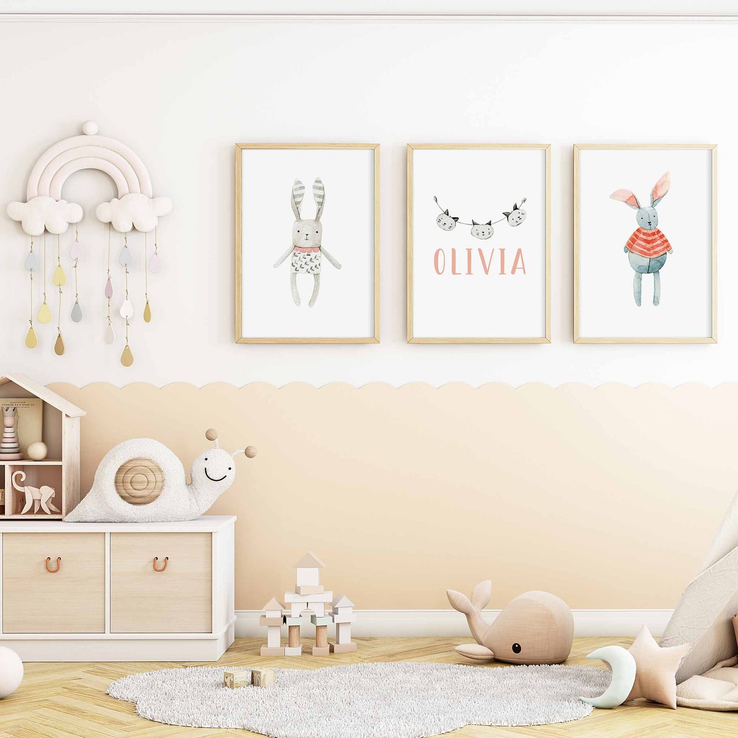 A set of 3 framed oak frames displaying a Scandinavian bunny and cat girl's name print decorated in a nursery 